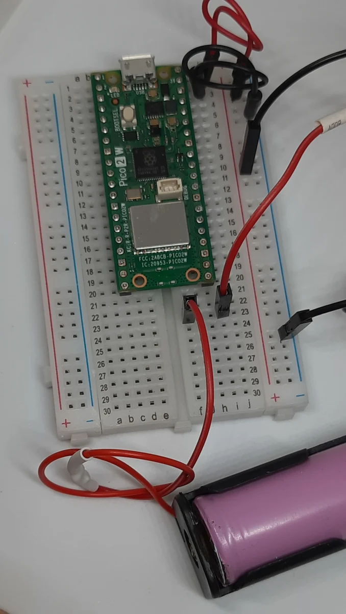 Raspberry Pi Pico 2 W breadboard circuit wiring for measuring current draw with multimeter in series